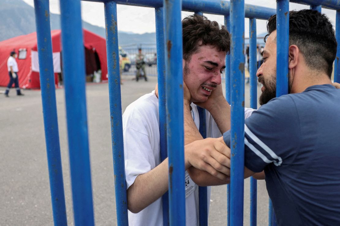 Syrian survivor Mohammad, 18, who was rescued at open sea, as he reunites with his brother Fadi, who came to meet him from the Netherlands, in Kalamata on June 16.