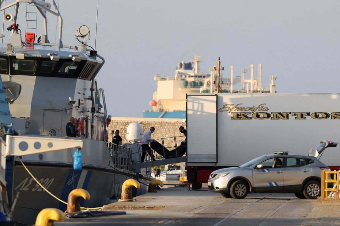 Workers transfer body bags carrying people who died in the tragedy.